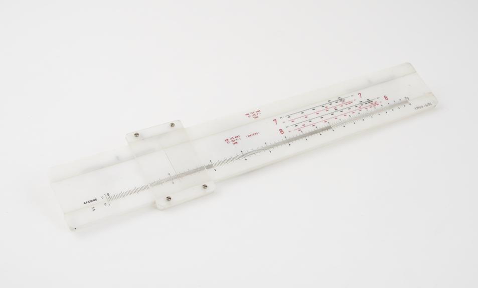 One of three Dutch slide rules, plastic, for artillery use.