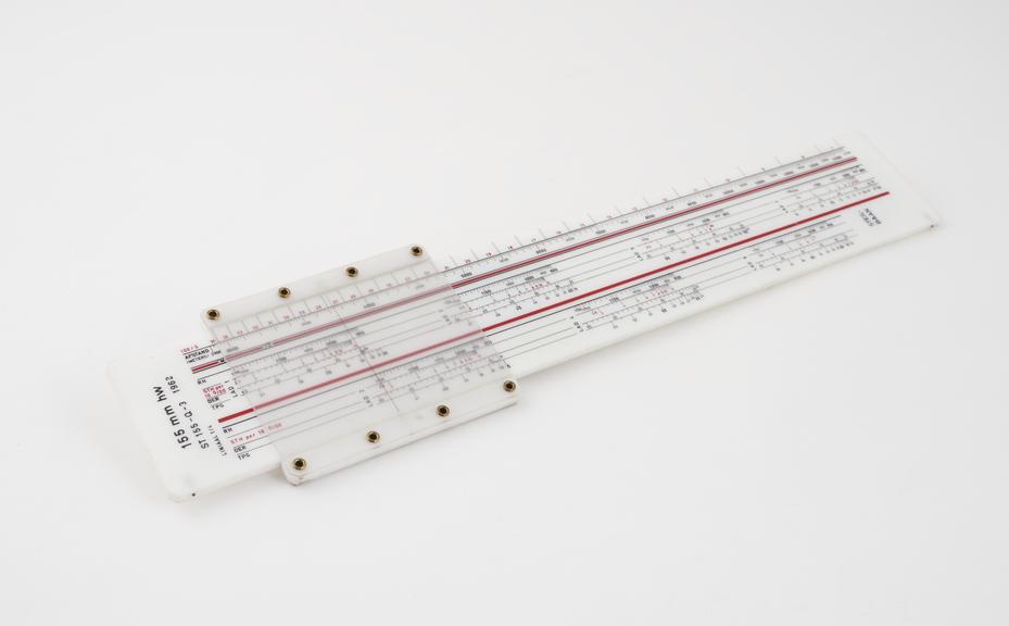 One of four Dutch slide rules, plastic, for artillery use.