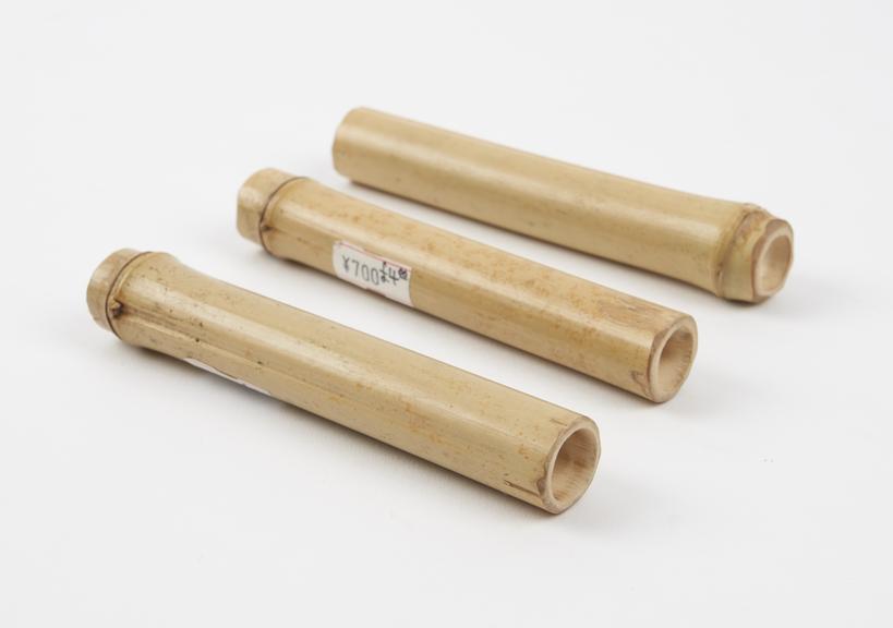 Three bamboo tubes, each sealed at one end, used to reduce pain