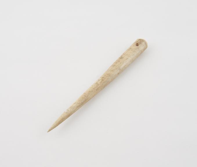 Needle, ivory, generally cylindrical, tapering to a point