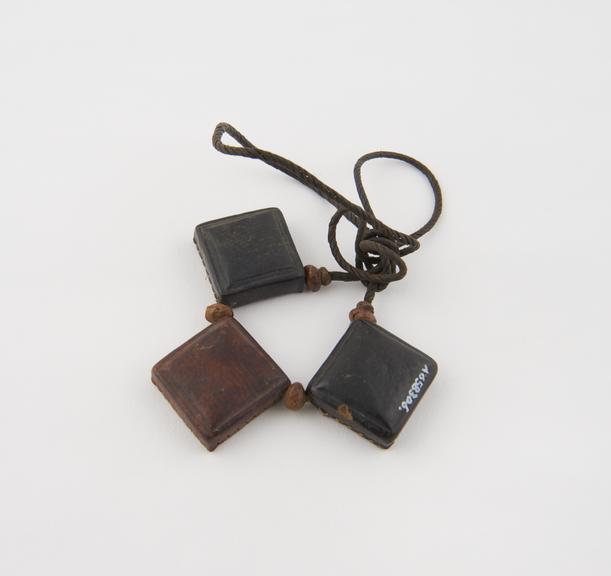 Amulet consisting of three square stitched leather cases