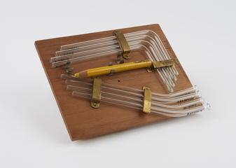 Chinagraph pencil and tubes on board