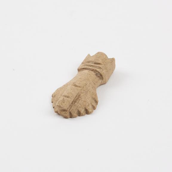 Carved ivory phallic amulet, in display case with others, Roman