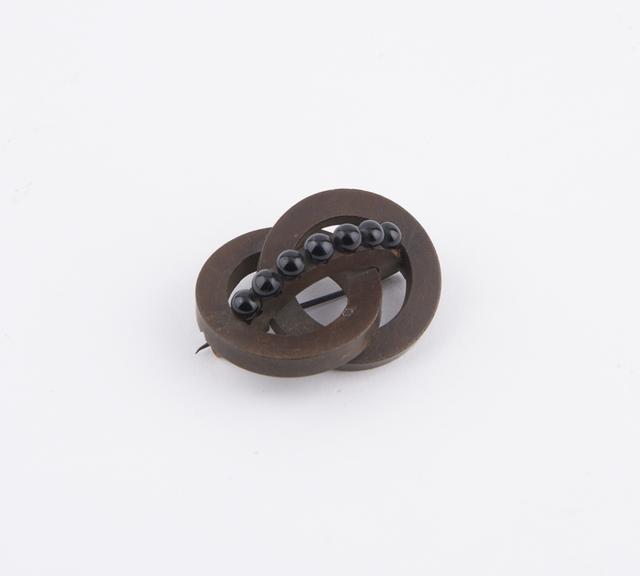 Vulcanite brooch in dark brown