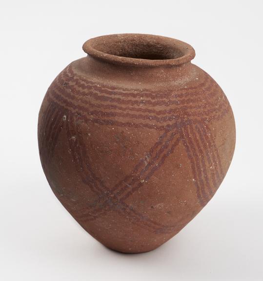 Earthenware jar, decorated with wavy lines in red