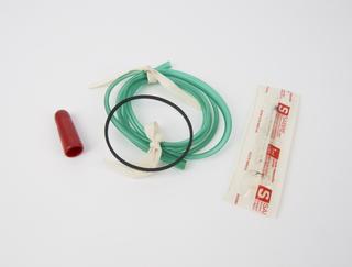 Green tubing, black rubber ring, red cap and 1ml syringe