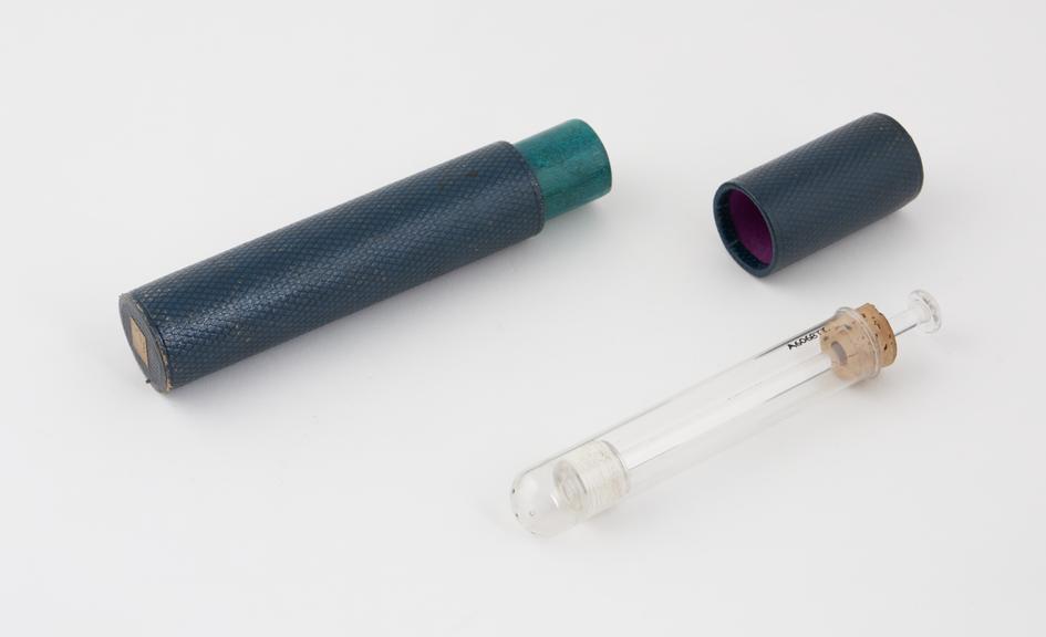 Glass vaginal syringe, in cardboard container, piston-action