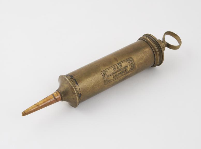 Brass enema syringe, piston action, by J. and S