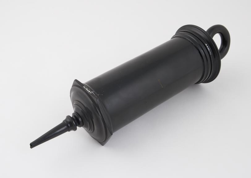 Plastic enema syringe, piston action, late 19th century