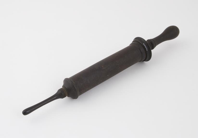 Plastic enema syringe, piston action, late 19th century