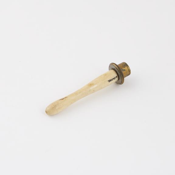 Bone nozzle and brass shield from an enema syringe