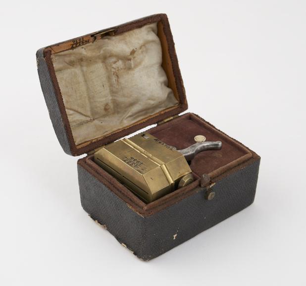 Brass scarificator, with 12 lancets, in case, by Evans, London