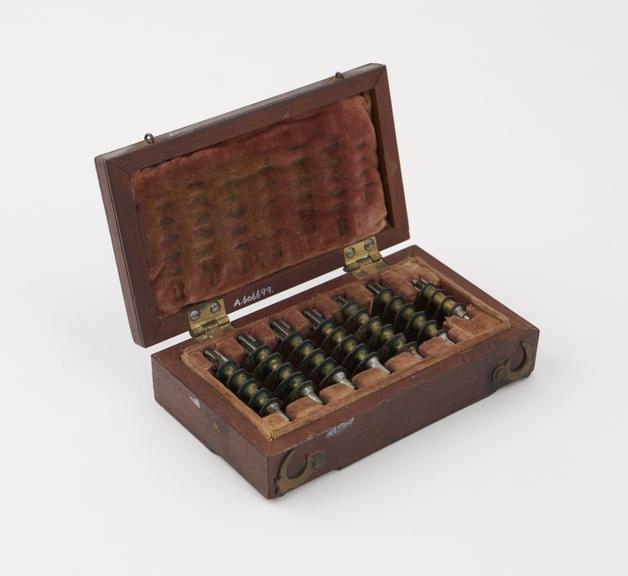 Wooden box, containing 7 spare lancets for scarificator