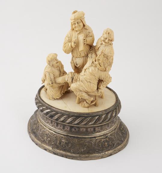 Ivory figure group depicting a blood-letting scene