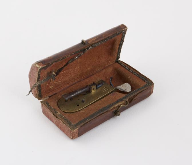 Brass automatic lancet, in leather covered case