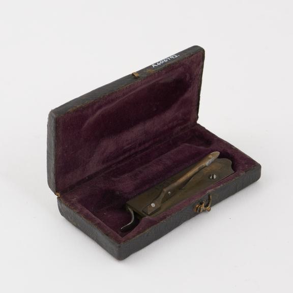 Brass automatic lancet in leather covered case