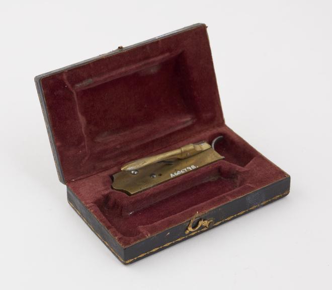 Brass automatic lancet in leather covered case