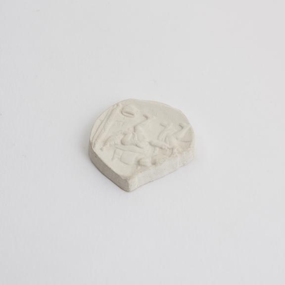 Plaster cast of a medal showing a doctor administering an enema