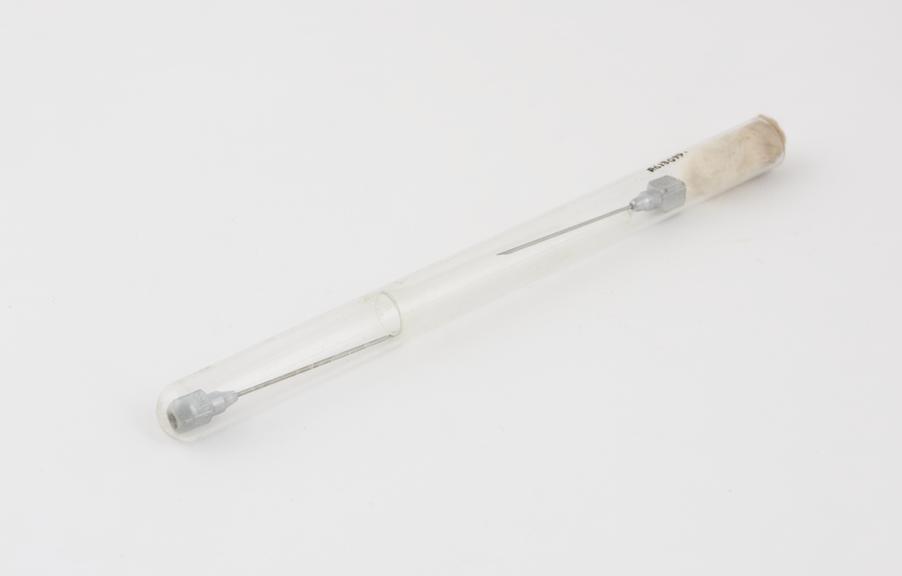 Two hypodermic needles, in glass tube, chrome plated mounts