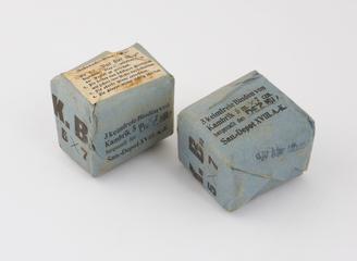 2 rectangular blue paper packages each containing 3 sterile cambric bandages