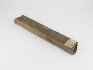 Wooden pipe containing concreted deposit from Chadderton Colliery