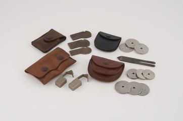Pouch containing telephone coin tester equipment