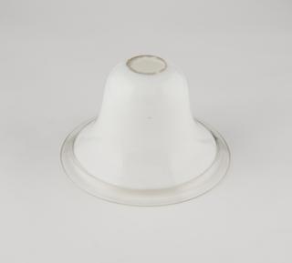 Bell-shaped glass shade fitted with a Metropolitan Vickers Electrical Co. Ltd Cosmos carbon filament lamp