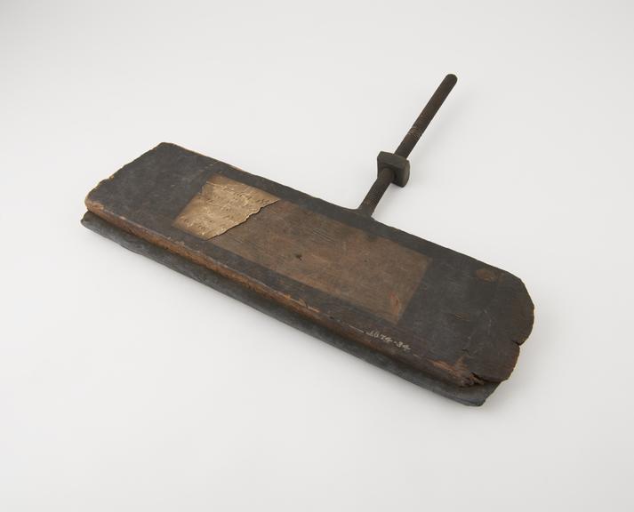 Wooden scraper for use in buddles