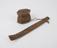 Carved wooden pipe holder containing two slender pieces of