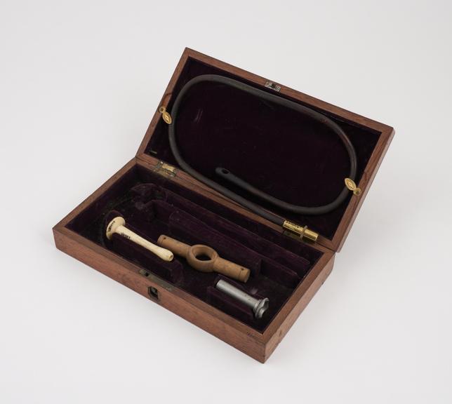 Part of an enema syringe set, cased