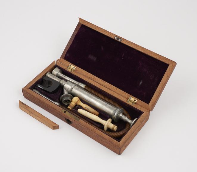 Enema syringe set, in wooden case, by Maw and Stevenson