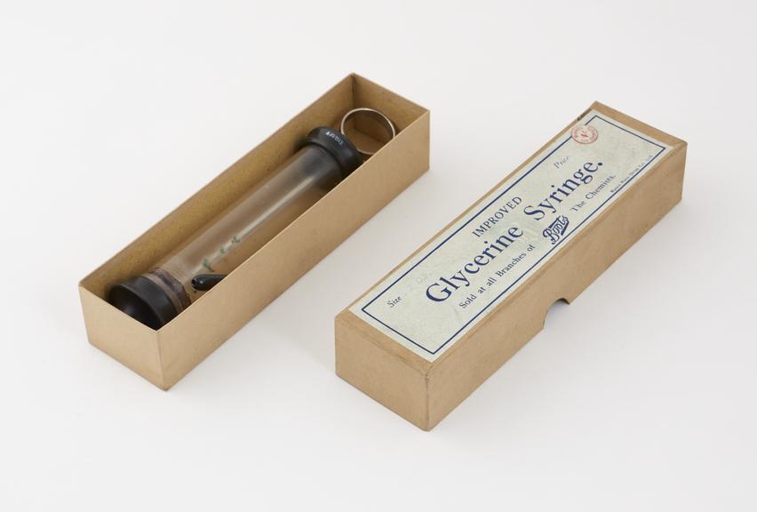 Glass and vulcanite piston-action syringe, in box