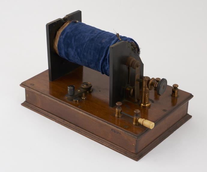 Velvet covered induction coil mounted on mahogany base