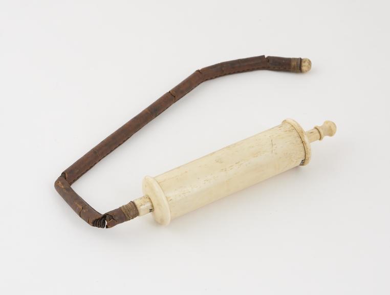 Ivory syringe, with a leather-covered spring tube