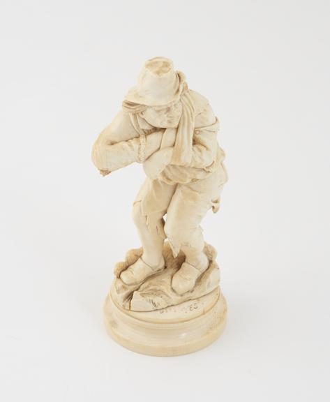 Ivory figure depicting a beggar with his arm in a sling