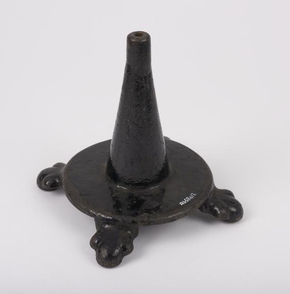 Elaborate cast iron stand with paw-shaped feet, painted black