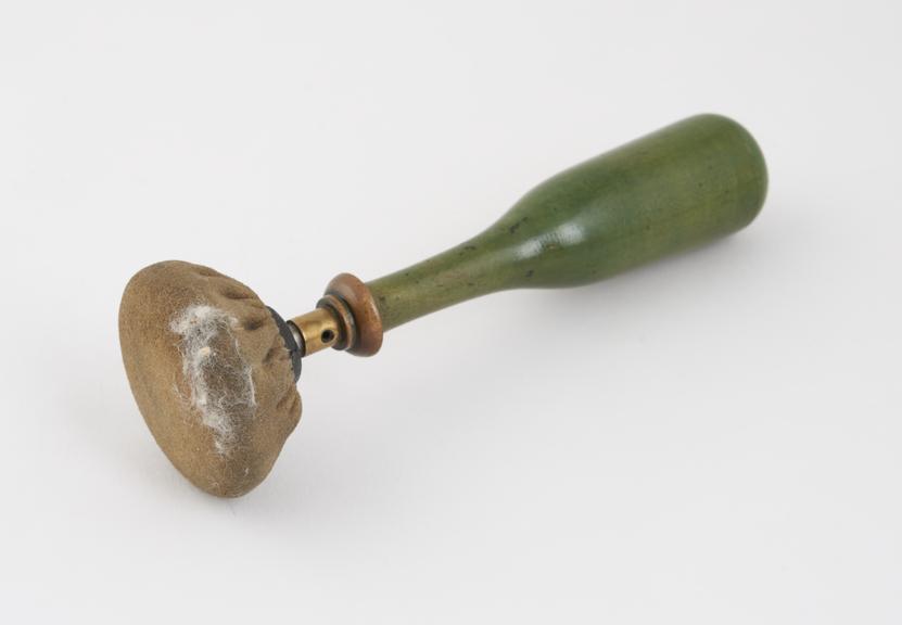 Electrode with green wooden handle and bell-shaped head of