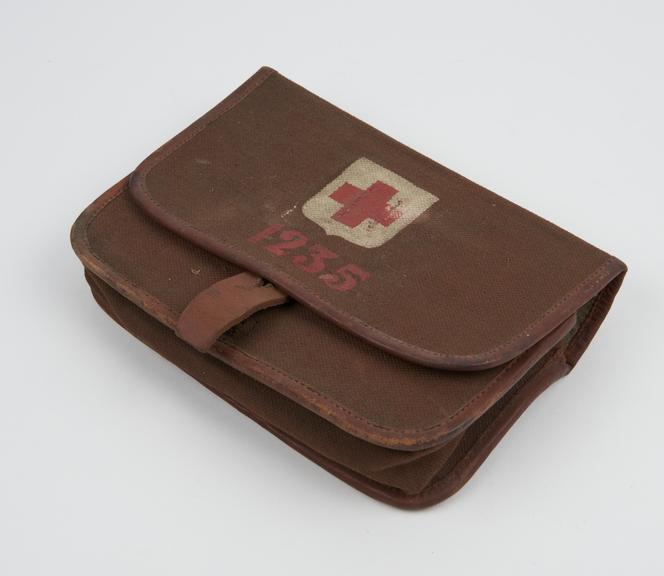 Canvas and leather pouch, containing packet of dressings