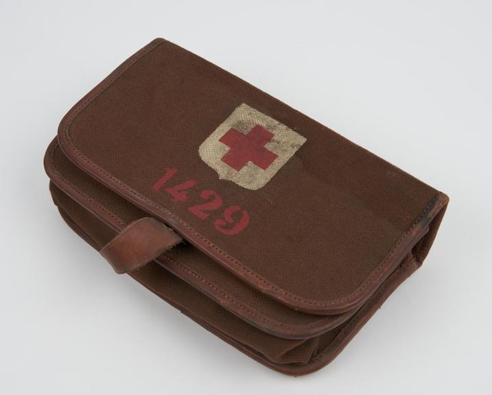 Canvas and leather pouch, containing 3 packets of dressings