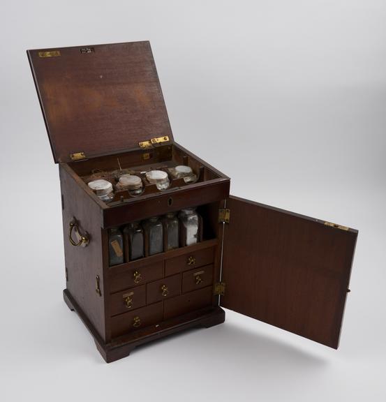 Medicine chest, with 17 glass bottles, 12 labelled, spatula