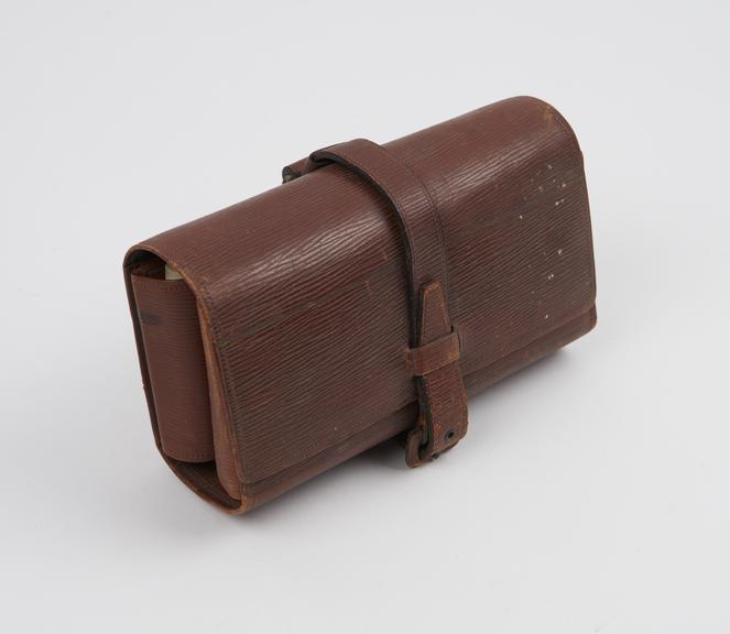 Folding leather pouch, containing 13 glass bottles