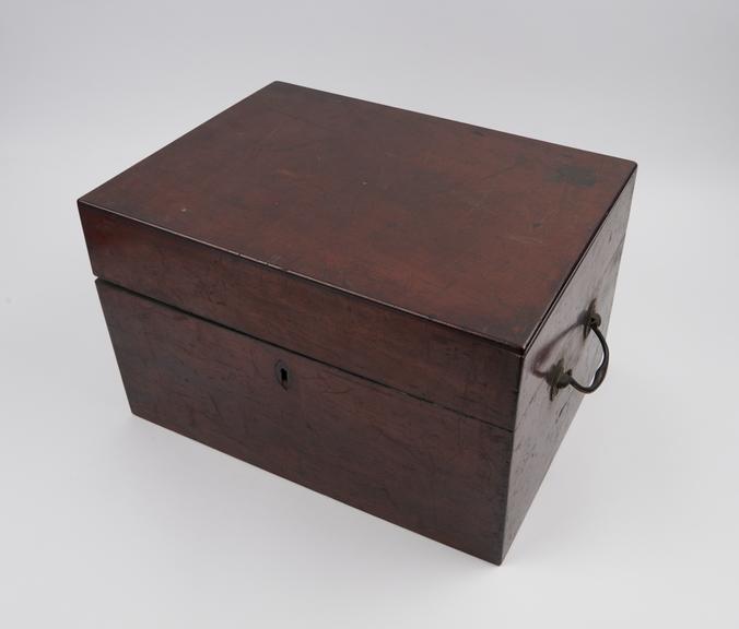 Mahogany medicine chest containing a glass decanter and 4 tin