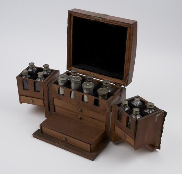 Small walnut(?) medicine chest with 2 hinged swing sections at