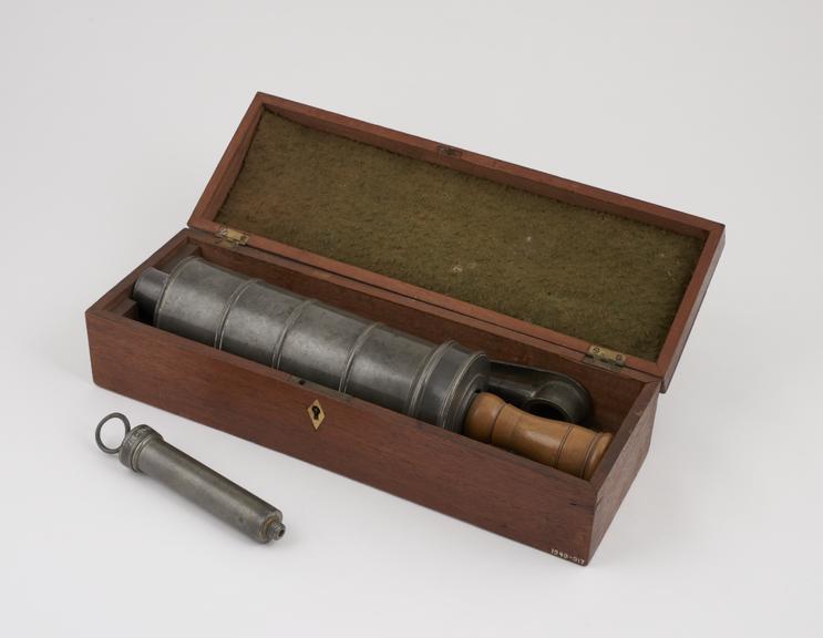 Two penter enema syringes with nozzles, in wooden case