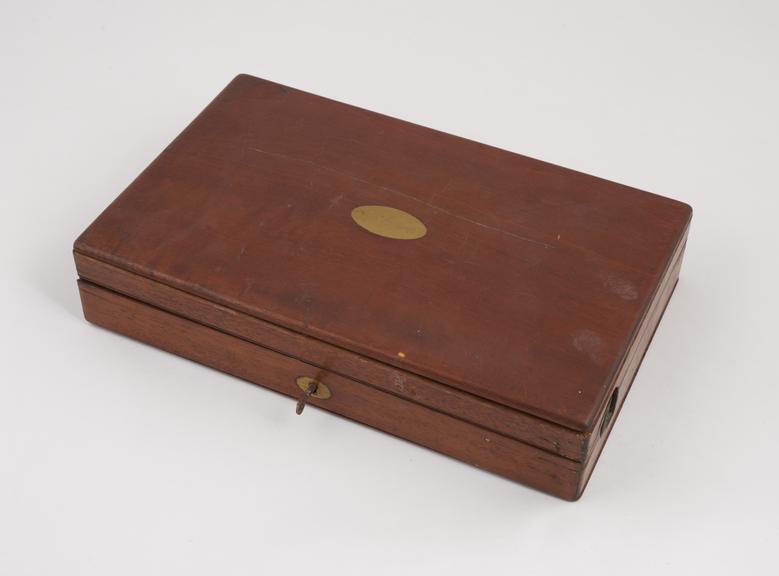 Wooden case containing enema set