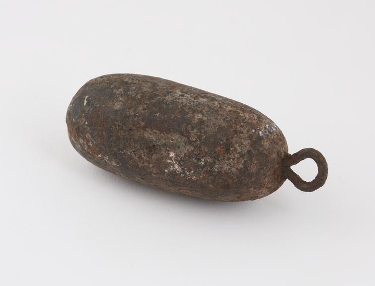 Iron weight, sausage-shaped with loop at one end for suspension