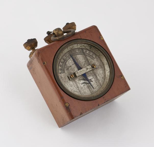 Voltmeter, metal face set in wooden casing, by Silvertown