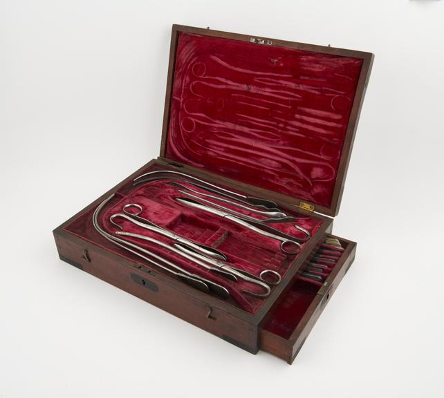 Lithotomy instrument set, incomplete, in damaged mahogany case