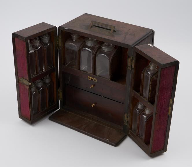 Medicine chest, tryptich front with 2 drawers, 19 glass bottles