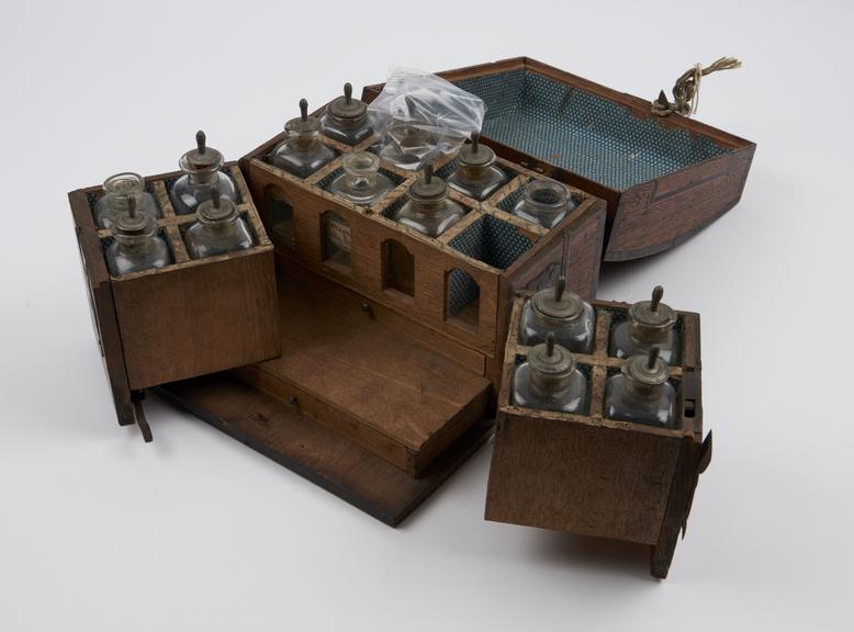 Oak medicine chest, hinges lid, main body holds eight bottles